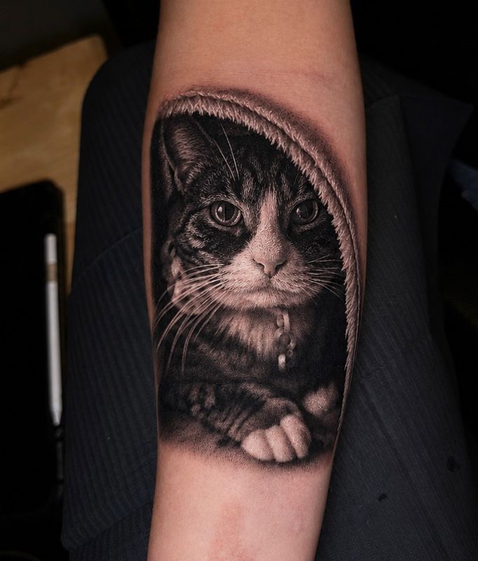 Black and grey cat portrait tattoo by Jonathan Cataño