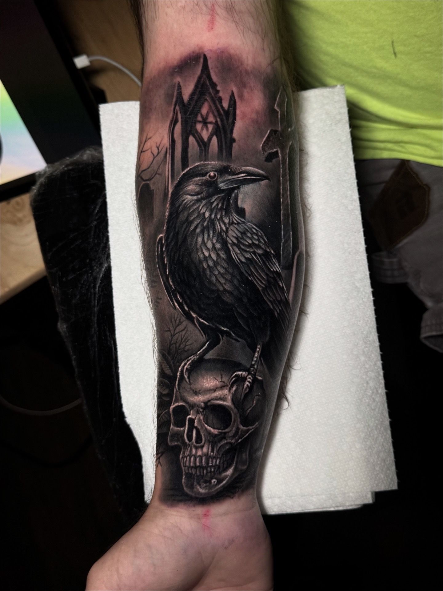 Black and grey raven and skull tattoo by Jonathan Cataño