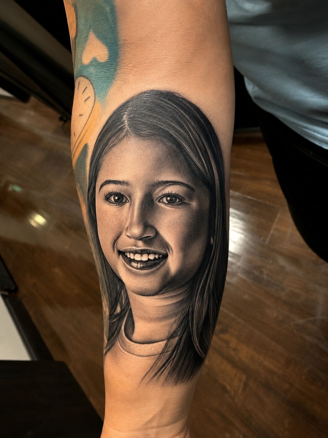 Realism portrait tattoo on an arm by Jonathan Cataño